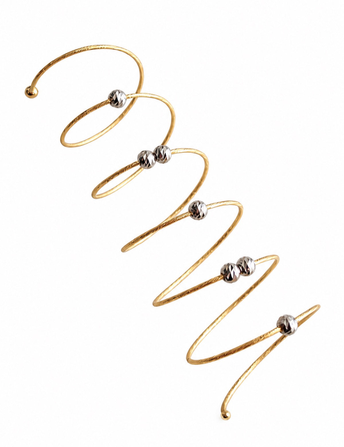 Diamond Cut Coil Ring — 18k gold spiral coil with white gold diamond-cut beads on white background